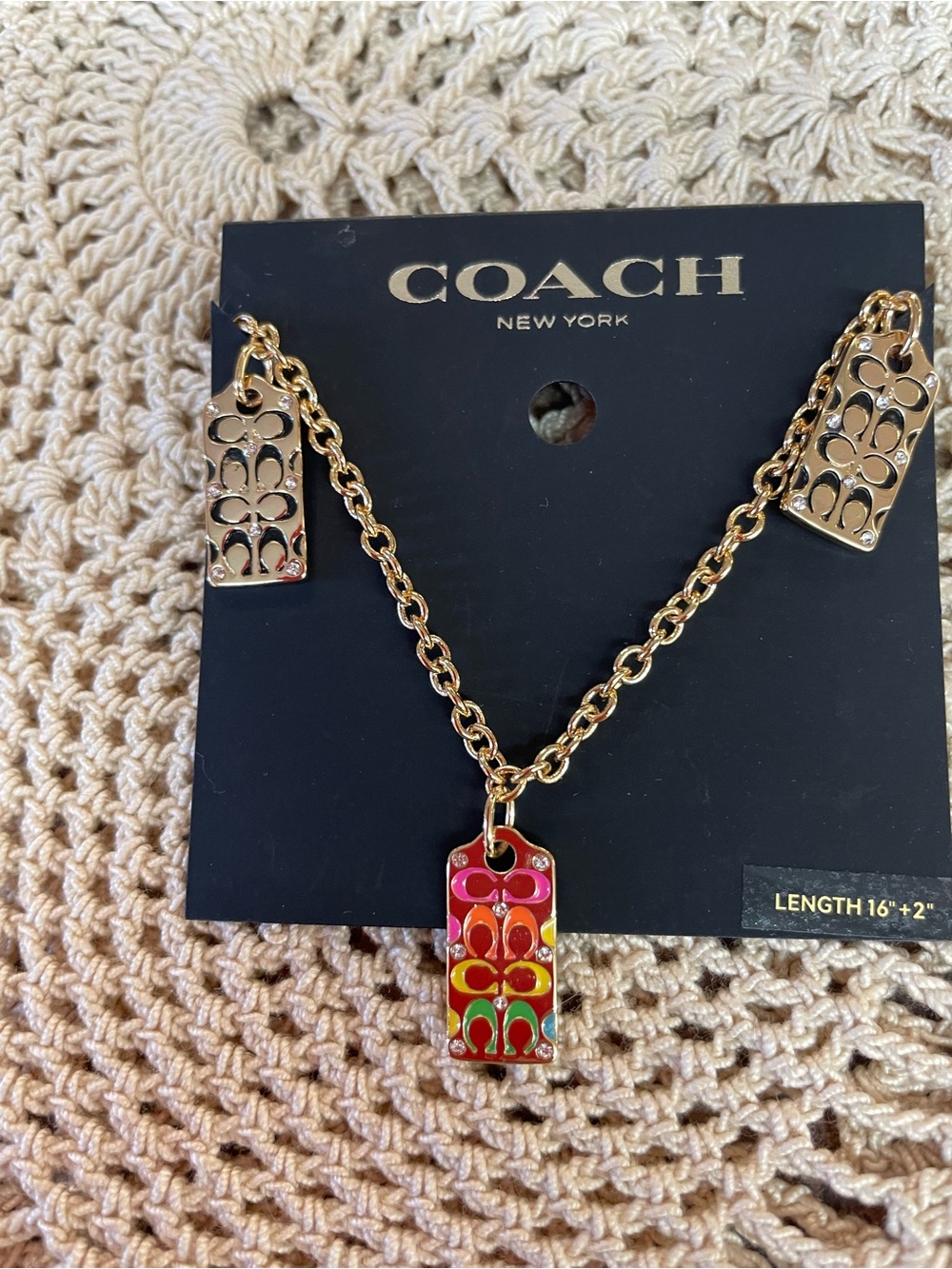 Coach New York gold-tone rainbow signature C tag bracelet